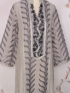 Close-up of intricate sequin beadwork and embroidery on ethnic style mesh maxi dress
