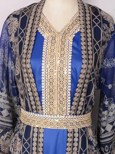 Close-up of elegant gold embroidery and sequins on royal blue Malaysian kaftan robe