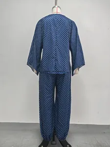 Full back view of women's navy polka dot two-piece set with batwing top and cuffed pants
