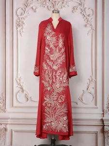 Élégante robe maxi rouge ethnique avec broderie complexe de paillettes dorées sur un mannequin