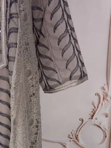 Close-up of ethnic mesh maxi dress featuring leaf sequin embroidery and lace detail