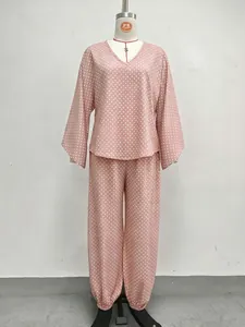 Detail view of pink polka dot lounge set featuring batwing sleeves and jogger pants.