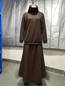 Detailed view of the minimalist brown fleece turtleneck sweatshirt and maxi skirt set.