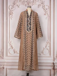 Detailed view of long-sleeved ethnic mesh dress with beadwork and embroidery decoration.