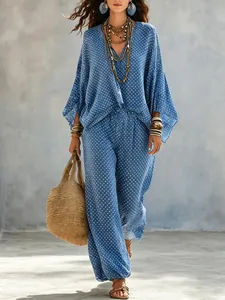 Boho polka dot two-piece set with batwing sleeve top and loose wide leg trousers.