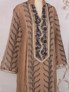 Detail view of ethnic long dress with intricate embroidery and sequin embellishments.