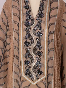 Detailed macro view of the intricate ethnic sequin embroidery and beadwork on this mesh long dress