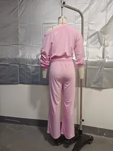 Back view of a pink two-piece tracksuit set with one-shoulder top and wide-leg pants