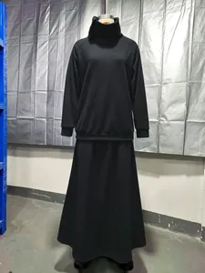 Two-piece black minimalist set featuring a high-neck sweatshirt and matching long skirt.
