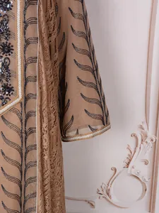 Close-up detail of ethnic style mesh dress featuring sequin embroidery and lace trim