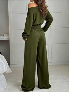Rear view of woman in olive green off-shoulder sweatshirt and wide-leg pants set
