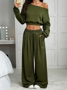 Detailed view of olive green off-the-shoulder top and high-waist wide-leg trousers