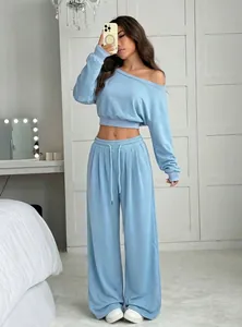 Stylish two-piece light blue lounge set with off-shoulder crop top and wide-leg pants