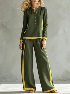 Fashionable two-piece set with green long sleeve tunic and yellow striped wide-leg trousers.