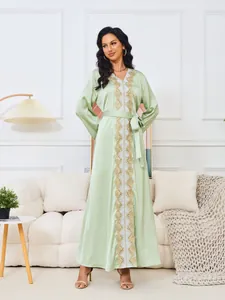 Elegante vestido largo verde menta con cuello en V, encaje dorado y cinturón de lazo