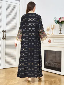 Rear view of elegant black kaftan dress with intricate gold beadwork embroidery