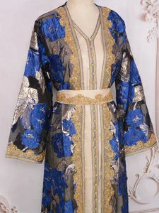 Detailed view of heavy embroidery and blue floral patterns on elegant party dress