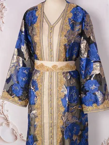 Close-up of luxury royal blue and gold beaded kaftan evening gown details.
