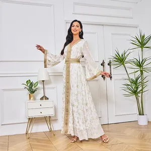 Détail de l'élégante robe maxi Abaya fleurie blanche et dorée à manches larges évasées.