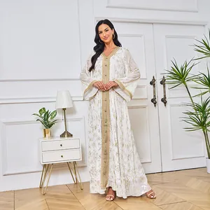 Vue détaillée de la robe Abaya blanche avec texture florale dorée et manches larges