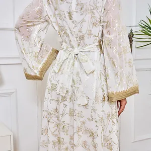 Vue détaillée du dos d'une abaya blanche avec motifs floraux dorés et lien à la taille