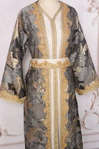 Exquisite detail of elegant gold embroidered maxi dress with luxury floral jacquard patterns