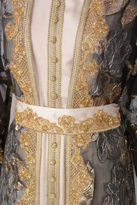 Close-up of golden heavy beadwork and floral embroidery on elegant party gown