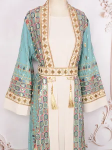 Detail of heavy sequin embroidery and gold tassels on elegant luxury formal dress