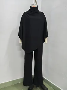 Elegant black women's two-piece set featuring poncho cape top and wide leg pants.