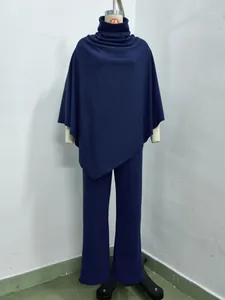 Navy blue women's two-piece set featuring a turtleneck poncho top and wide-leg pants.