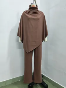 Detailed view of a brown two-piece set featuring a poncho top and wide-leg pants.