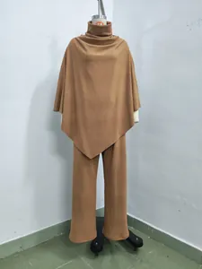 Detailed view of camel thermal poncho top and wide-leg pants set on a mannequin