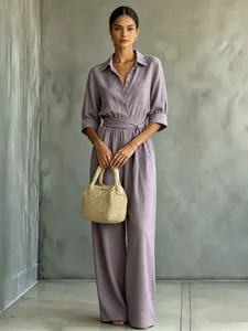 Full view of women's casual mauve wide-leg jumpsuit with shirt collar and tie-waist