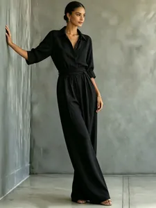 Chic black mid-sleeve shirt jumpsuit featuring a tied waist and wide leg design for women