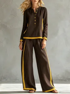 Detailed view of women's brown and yellow contrast wide-leg pant set with button top.
