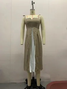 Detail view of khaki and white patchwork camisole midi dress on a mannequin form