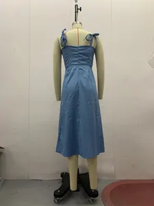 Blue midi dress with shoulder ties shown from behind on a professional mannequin