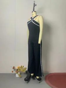Side view of black cross halter top and wide-leg trousers set with white stripes