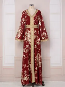 Vue détaillée d'un peignoir Abaya bordeaux avec motifs floraux dorés et bordure en dentelle.