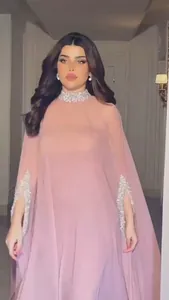 Elegante roze cape maxi-jurk met glinsterende zilveren pailletten details op de nek