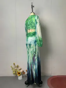 Back view of printed long sleeve maxi dress featuring cutout detail and vibrant artistic patterns