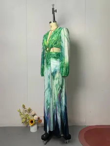 Detailed side view of a green abstract floral print long sleeve maxi dress with waist cutout