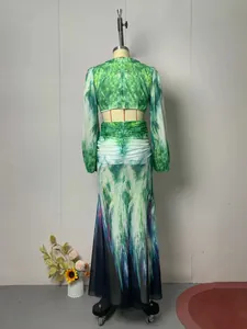 Back view of a long-sleeved green watercolor print holiday maxi dress on mannequin
