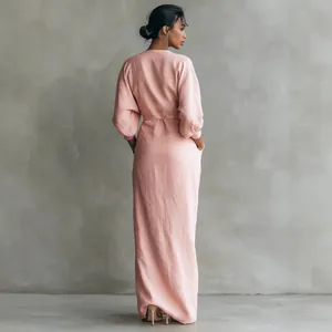 Elegant pink V-neck maxi dress featuring pleated waist and long sleeves back view