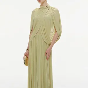 Close-up detail of an elegant pleated chiffon maxi dress with high neck and caped sleeves.