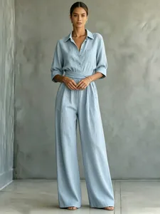 Chic women's light blue wide-leg jumpsuit featuring a shirt collar and belted waistline