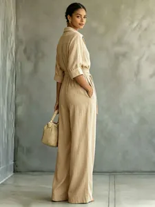 Elegant beige mid-sleeve shirt jumpsuit for women featuring a stylish wide-leg fit