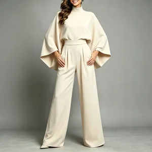 Elegant cream high-neck two-piece set with cape sleeves and matching wide-leg pants