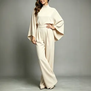Elegant cream two-piece wide-leg set with high neck and cape sleeve top