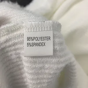 Detail of white wide leg romper showing fabric label with 95% polyester composition